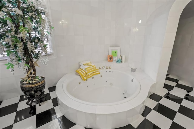 bathroom with tiled bath and tile walls