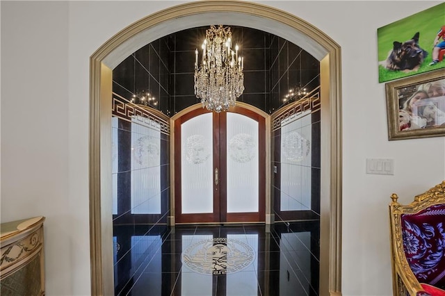 room details with french doors and an inviting chandelier