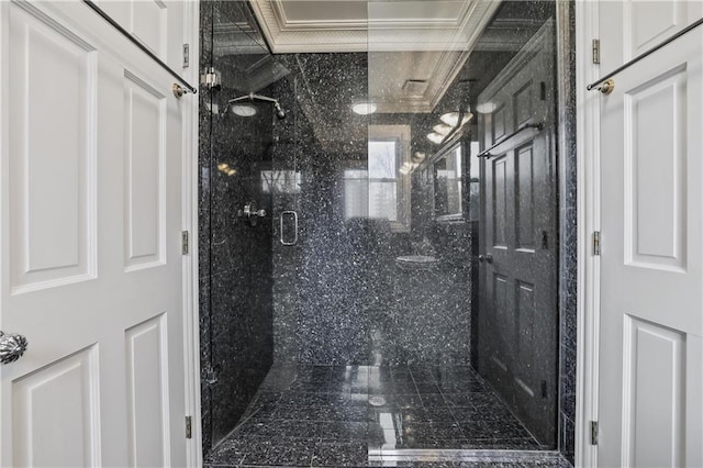 bathroom with an enclosed shower and crown molding