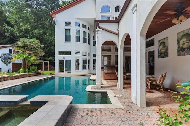 back of house featuring a patio area, ceiling fan, and exterior kitchen