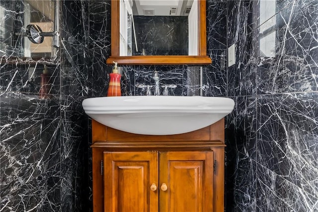 bathroom with vanity and tile walls