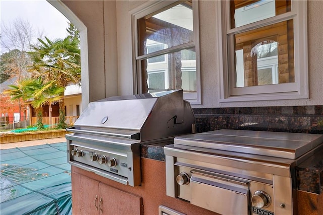 view of patio / terrace with area for grilling, grilling area, and a covered pool