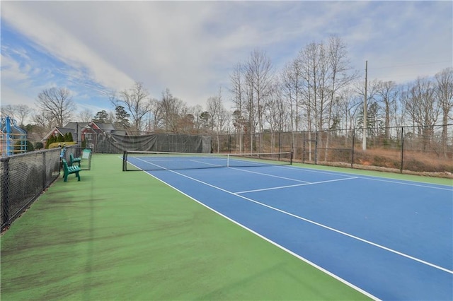 view of tennis court with basketball hoop