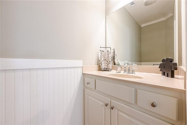 bathroom featuring crown molding, visible vents, and vanity