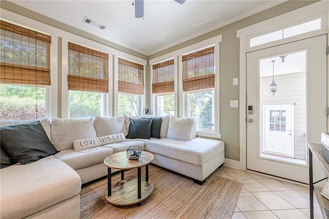 living room with crown molding, visible vents, a ceiling fan, and light tile patterned flooring