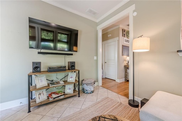 interior space with tile patterned flooring, visible vents, baseboards, and crown molding