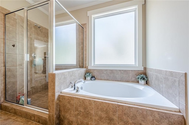 bathroom with a shower stall, a garden tub, and ornamental molding