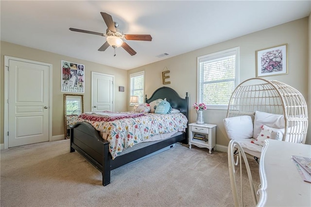 bedroom featuring visible vents, ceiling fan, light carpet, and baseboards