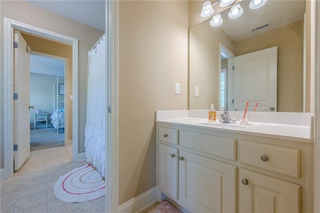 full bathroom with tile patterned floors, vanity, baseboards, and visible vents