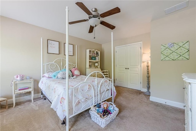 carpeted bedroom featuring visible vents, baseboards, and a ceiling fan