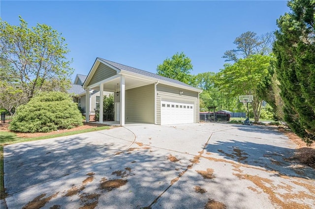 view of side of property featuring a garage and concrete driveway