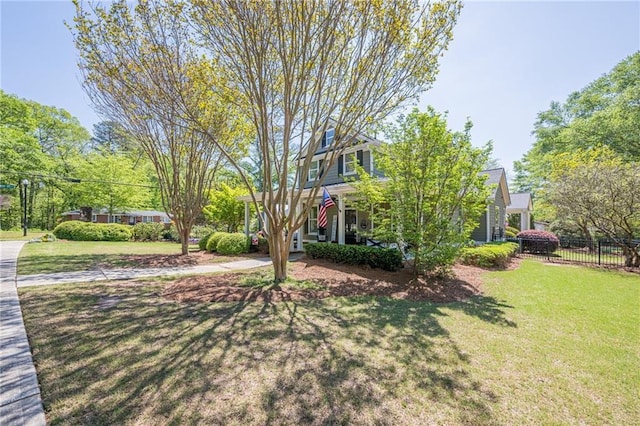 view of yard with a porch and fence