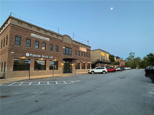 view of building exterior with uncovered parking