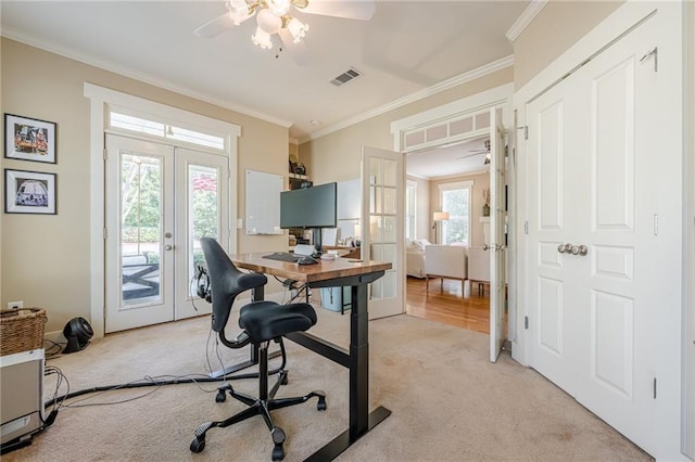 office space featuring ornamental molding, french doors, a ceiling fan, visible vents, and light colored carpet