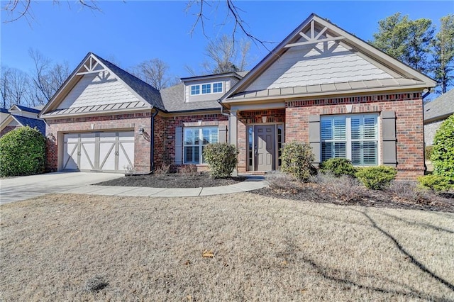 craftsman-style house with a garage, driveway, and brick siding