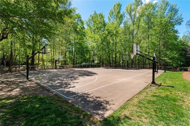 view of sport court featuring a lawn