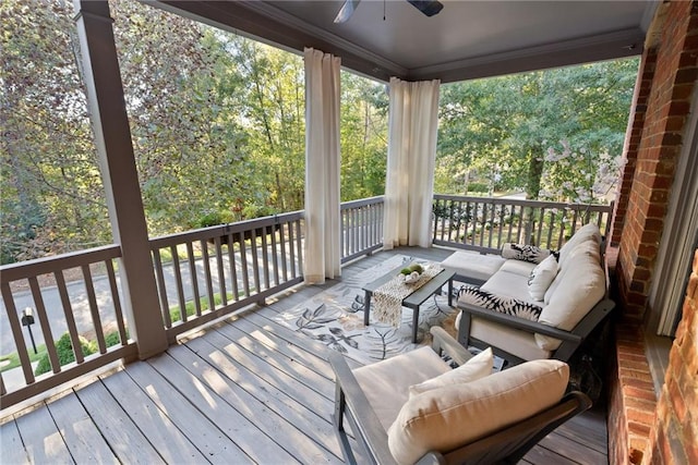 wooden deck featuring outdoor lounge area and ceiling fan