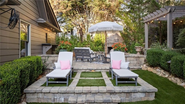 view of patio / terrace featuring a pergola and exterior fireplace