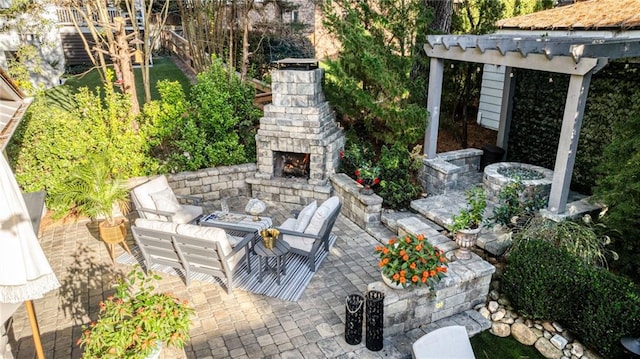 view of patio / terrace with an outdoor living space with a fireplace