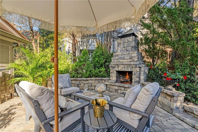 view of patio featuring an outdoor stone fireplace