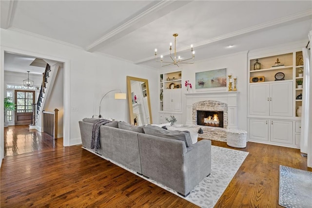 living room featuring a fireplace, built in shelves, ornamental molding, and dark wood-type flooring