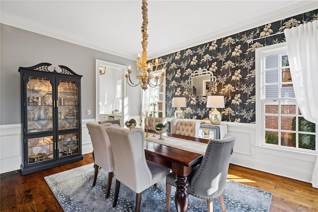 dining room featuring dark hardwood / wood-style flooring, an inviting chandelier, and crown molding