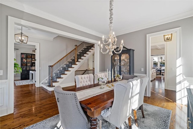 dining space with crown molding and hardwood / wood-style floors