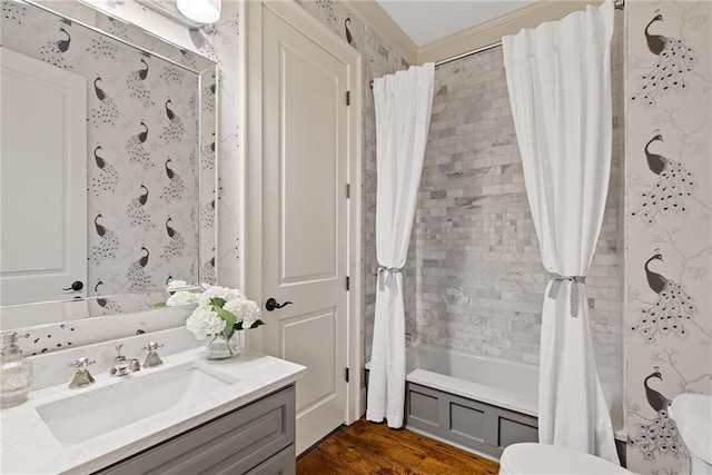 bathroom with crown molding, vanity, shower / tub combo, and hardwood / wood-style flooring