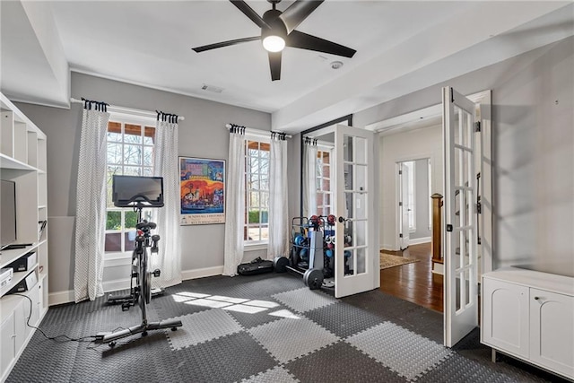 exercise room featuring ceiling fan and french doors