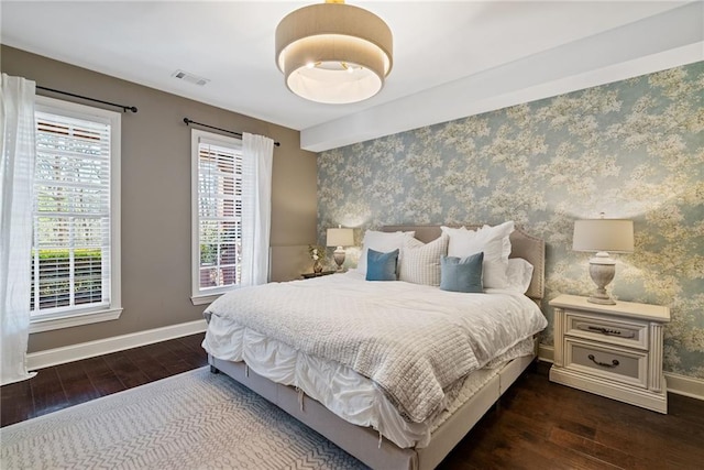 bedroom with dark wood-type flooring