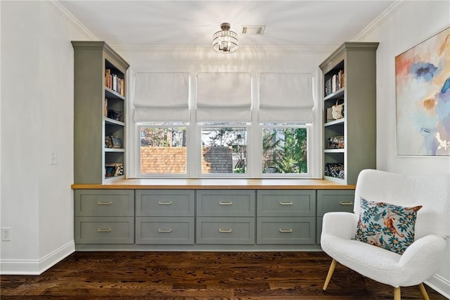 living area with dark hardwood / wood-style floors, plenty of natural light, and crown molding