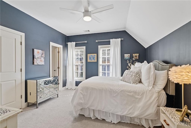 carpeted bedroom with ceiling fan and vaulted ceiling