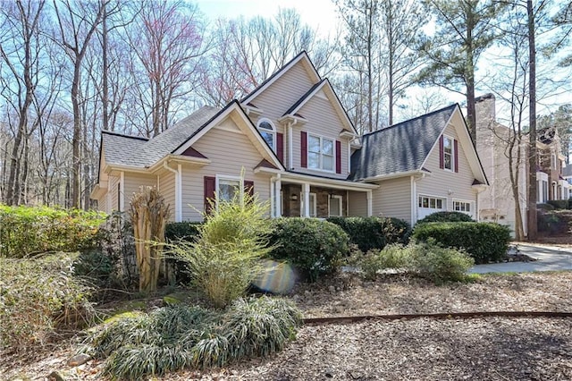 traditional-style house with roof with shingles