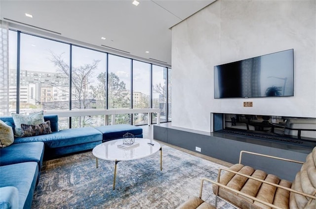 living room featuring expansive windows and a healthy amount of sunlight