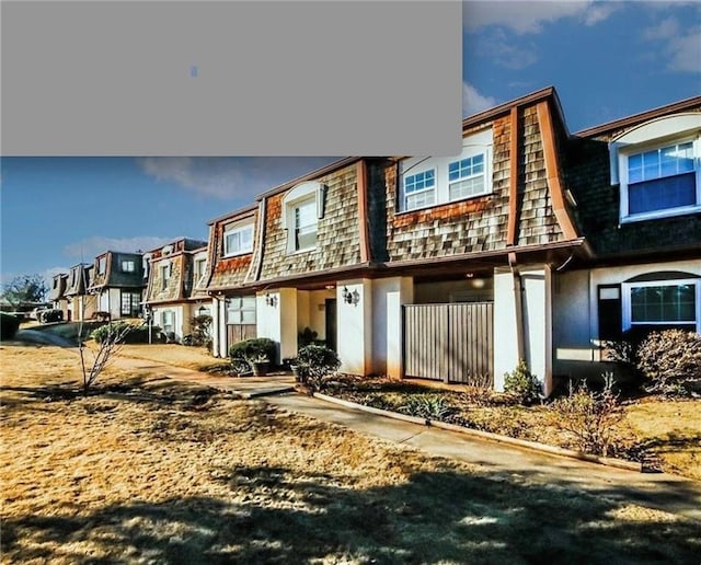 172 Rue Fontaine, Lithonia, GA 30038 - rear view of house featuring mansard roof, a residential view, and stucco siding