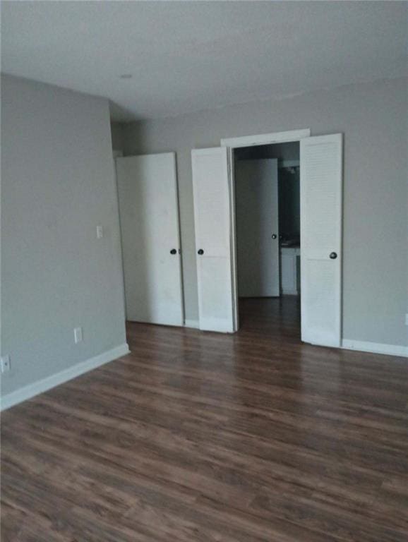 172 Rue Fontaine, Lithonia, GA 30038 - empty room with dark wood-style flooring and baseboards