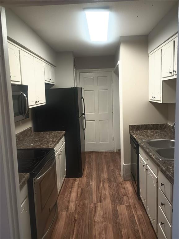 kitchen featuring black appliances, white cabinetry, dark wood-type flooring, and sink