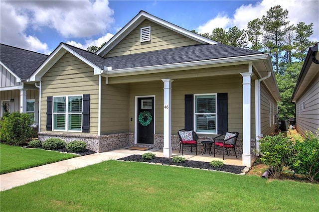 46 Courtyard Ln, Cartersville, GA 30120 - view of front of house with a front lawn, a porch, brick siding, a shingled roof, and board and batten siding