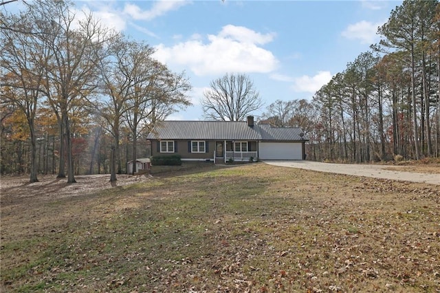 ranch-style house with a garage and a front lawn