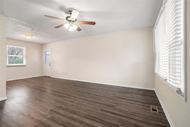 empty room with dark wood-type flooring