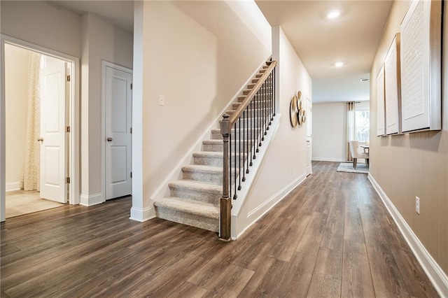 stairway with hardwood / wood-style floors