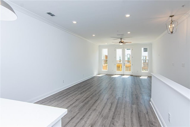 unfurnished living room featuring ornamental molding, french doors, visible vents, and baseboards