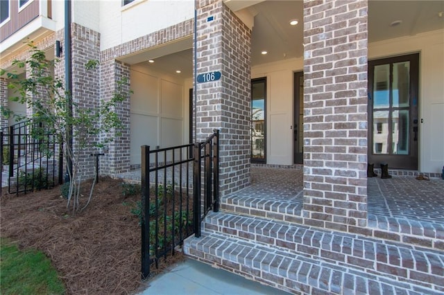 doorway to property featuring brick siding