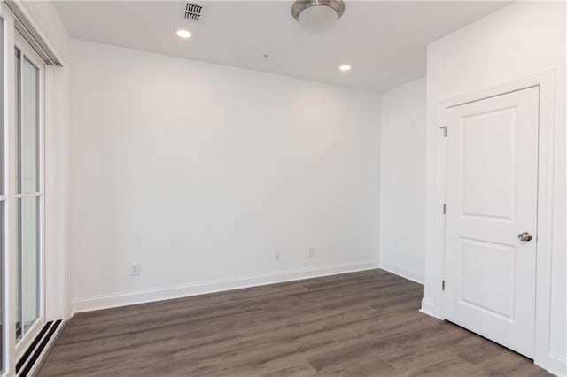 unfurnished bedroom featuring baseboards, wood finished floors, and recessed lighting