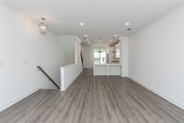 unfurnished living room featuring light wood-type flooring, baseboards, and recessed lighting