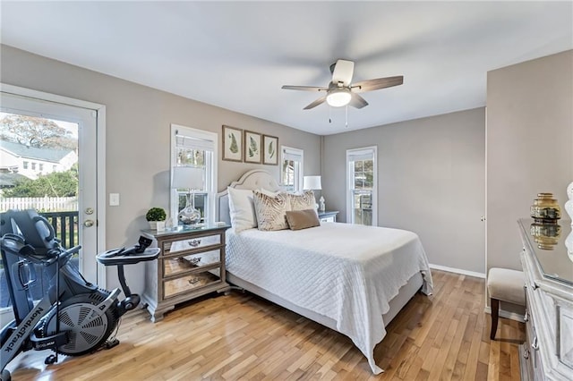 bedroom with access to exterior, baseboards, light wood finished floors, and a ceiling fan