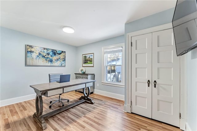 office area with light wood-style flooring and baseboards