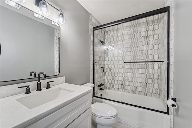 full bath with combined bath / shower with glass door, vanity, and toilet