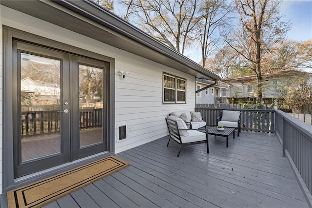 wooden deck with an outdoor hangout area and french doors