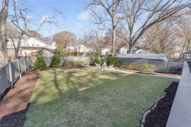 view of yard with a residential view and a fenced backyard